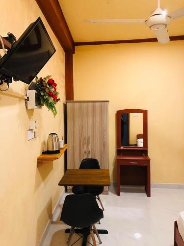 a room with a table and two chairs and a mirror at Cinnamon Airport Residencies in Katunayaka