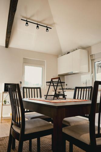 a kitchen with a table and chairs in a room at Casa da Vira - Alojamento Local in Arcos de Valdevez