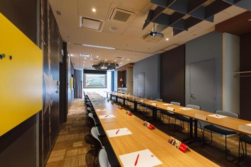 a conference room with long tables and chairs at ibis Lyon Carre De Soie in Vaulx-en-Velin