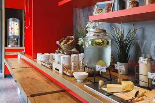 a display case in a store with cheese and a jar at ibis Lyon Carre De Soie in Vaulx-en-Velin