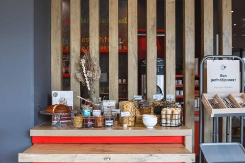 a display of food items on a table in a store at ibis Lyon Carre De Soie in Vaulx-en-Velin