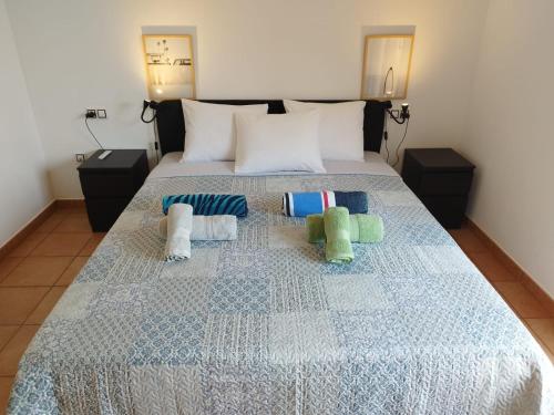a bed with four pillows on top of it at Casa La Ola Majanicho - Monthly Stays in Majanicho