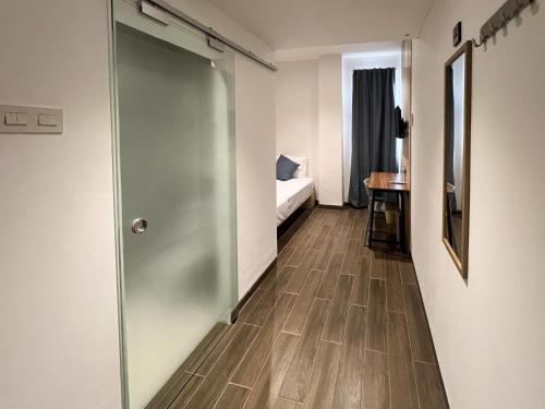a corridor of a room with a sliding door at Box City Hotel Mojokerto in Mojokerto