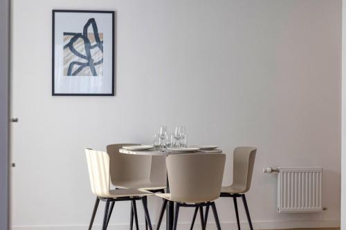 a dining room with a table and chairs at KOSY APPART'HÔTELS - Résidence du Lac in Aix-les-Bains