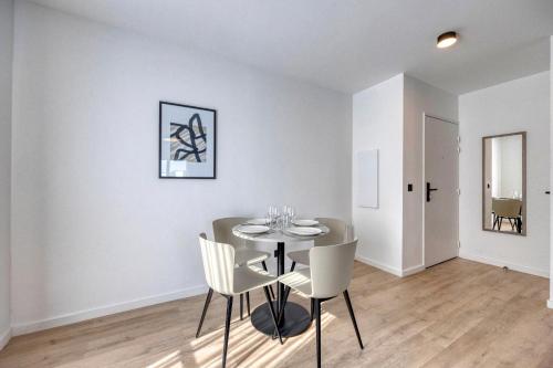 a dining room with a table and chairs at KOSY APPART'HÔTELS - Résidence du Lac in Aix-les-Bains