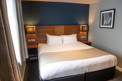 a bedroom with a large bed in a hotel room at The White Hart by Innkeeper's Collection in Hook