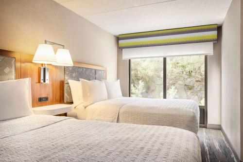 a hotel room with two beds and a window at Hampton by Hilton Shelton in Shelton