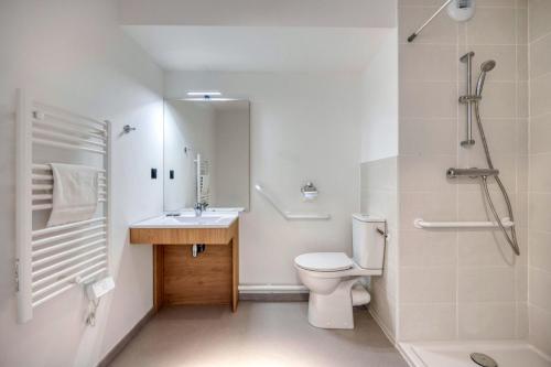 a bathroom with a toilet and a sink and a shower at KOSY APPART'HÔTELS - Résidence du Lac in Aix-les-Bains