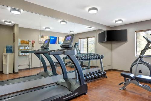 a gym with two tread machines and a mirror at Comfort Inn South - Springfield in Springfield
