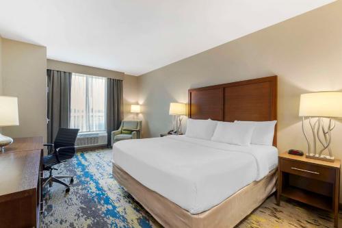 a hotel room with a large bed and a desk at Comfort Inn & Suites Valdosta I-75 in Valdosta