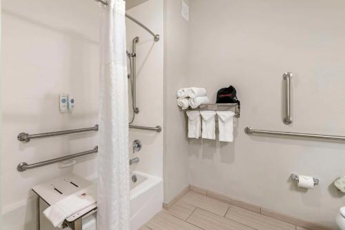 a bathroom with a tub and a toilet and towels at Comfort Inn & Suites Valdosta I-75 in Valdosta