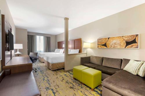 a hotel room with a bed and a couch at Comfort Inn & Suites Valdosta I-75 in Valdosta