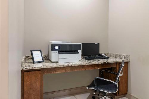 a desk with a computer and a printer on it at Comfort Inn & Suites Valdosta I-75 in Valdosta