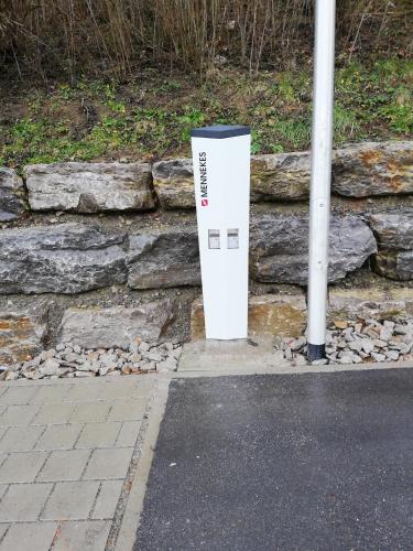 a parking meter sitting next to a stone wall at Hotel - Restaurant Sonneneck in Dornstetten