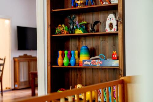 a book shelf filled with lots of colorful items at OderPoint#Sauna#Jacuzzi in Gozdowice