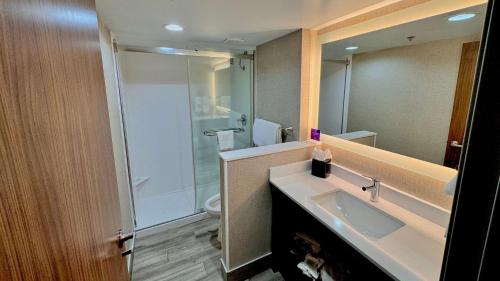 a bathroom with a sink and a shower and a toilet at Sleep Inn Oakbrook Terrace - Chicago in Oakbrook Terrace