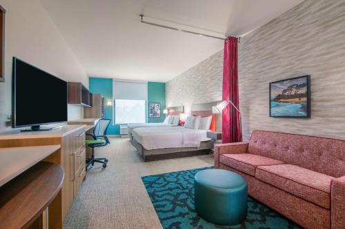 a hotel room with a couch and a bed at Home2 Suites By Hilton Kingsland in Kingsland
