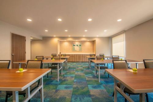 a conference room with tables and chairs and a podium at Home2 Suites By Hilton Kingsland in Kingsland