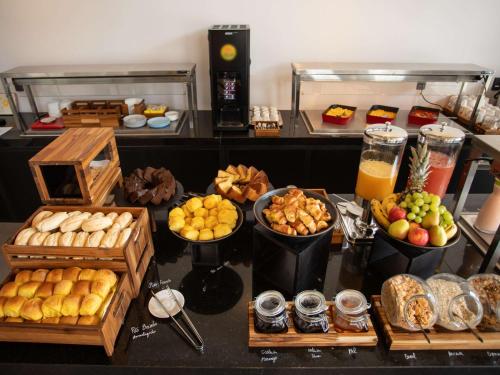 a buffet with different types of food on a table at Ibis Serra Talhada in Serra Talhada