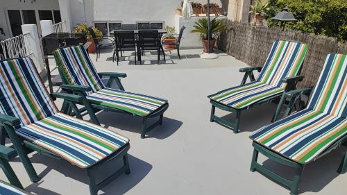 a group of lawn chairs sitting on a patio at Son Massanet con Piscina y Fantásticas Vistas, ideal para ciclistas y senderistas in Campanet