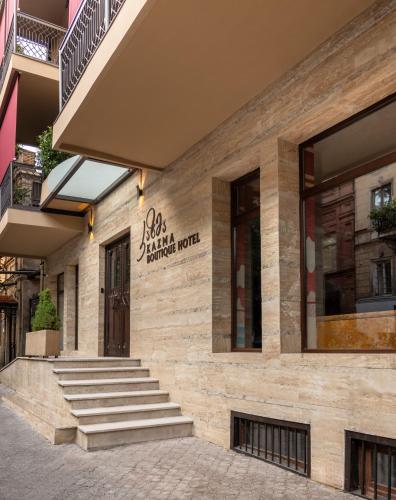 a building with stairs in front of a store at Kazma Boutique Hotel in Tbilisi City
