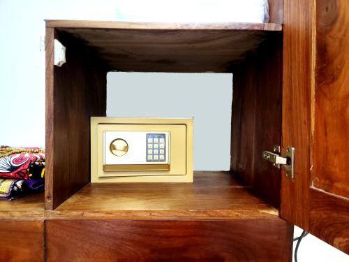 a small cabinet with a microwave in a room at Treasures of Zanzibar House in Zanzibar City