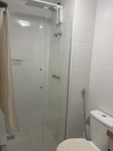 a bathroom with a glass shower with a toilet at Blend Apartments in Brasília