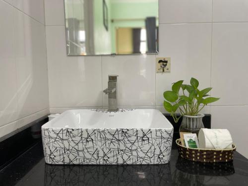 a white sink in a bathroom with a mirror at Vi TamCoc Hotel in Ninh Binh
