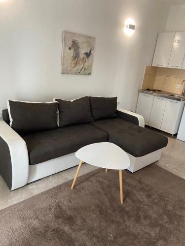 a living room with a couch and a table at Montebello Inn apartments in Ulcinj