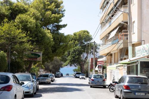 a street with cars parked on the side of a road at The Pines apartment in Palaiá Fókaia