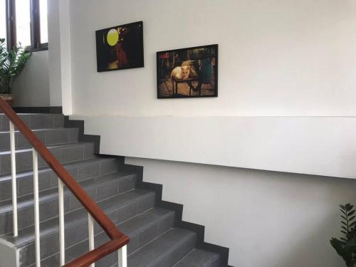 a staircase with two pictures on the wall at Manoo House E in Pratunam
