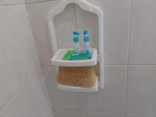 a bathroom with a sink with two bottles of water at Apto Casa A Simples, Central e Aconchegante in Corumbá