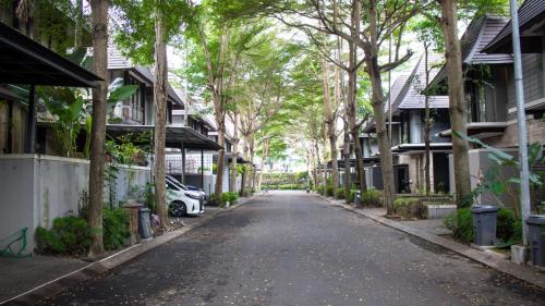 an empty street with trees and houses on either side at Hyarta Villa 3 BR Block C in Kejayan
