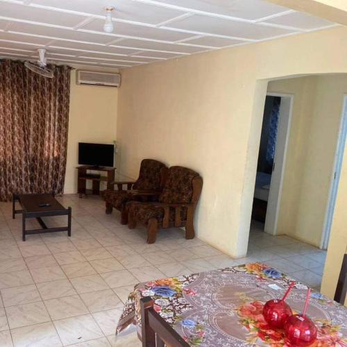a living room with a couch and a television at Harmony house apartments in Ker Bakary