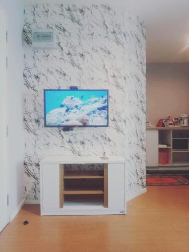 a living room with a flat screen tv on a wall at Studio Seaview Jomtien floor12 23sqm in Jomtien Beach