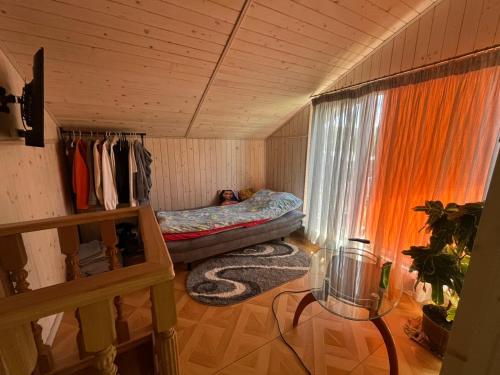 a small room with a bed and a window at Cottage 'Carolina' with hot tub, sauna and BBQ area in Kosiv