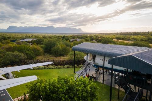 an aerial view of a building with a stairway to a plane at Aerotel in Hoedspruit