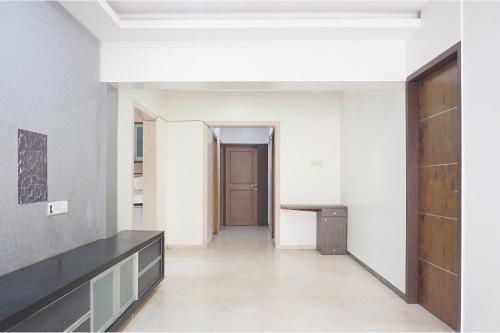 an empty room with a door and a hallway at FabExpress Shree Haree Residency - Nr Mazda Garden View in Pune