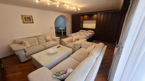 a living room with couches and a couch and a table at City Gate in Sarajevo