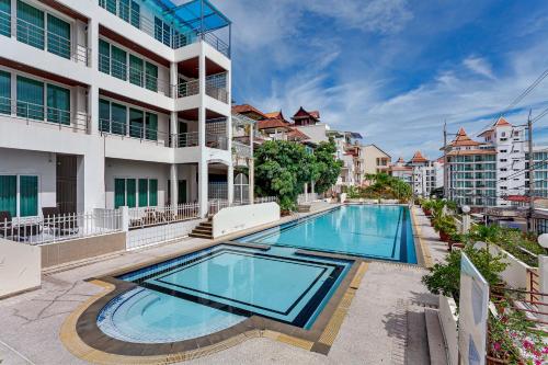 an image of a swimming pool in front of a building at Grosvenor House - Olympic Pool - Pattaya in Pattaya South