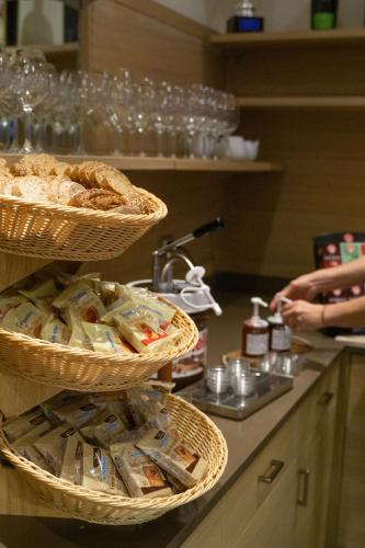 three baskets of food on a counter in a kitchen at Hotel Bel Sit in Comano Terme