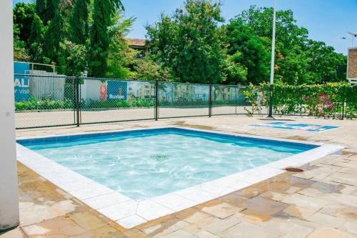 a swimming pool in a yard with a fence at 3 bedroom mombasa CBD with AC in Mombasa