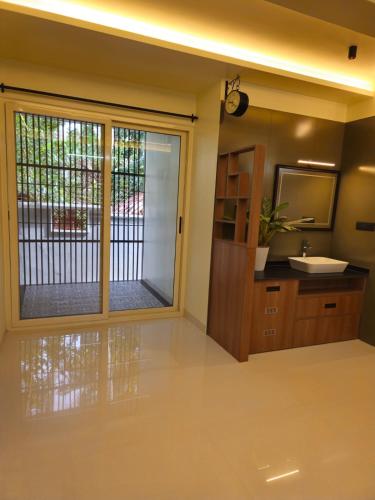 a bathroom with a sink and a mirror at HRISHI Guest Suites 2BHK in Trivandrum