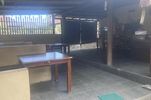 a room with a wooden table in a building at Rama Garden Lembongan in Nusa Lembongan