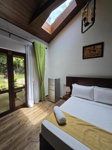 a bedroom with a large bed and a window at Villa D55 in Kandy