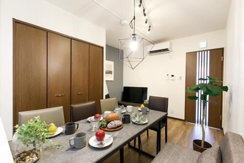 a dining room with a table with food on it at Tsutsuicho STAY in Nagoya