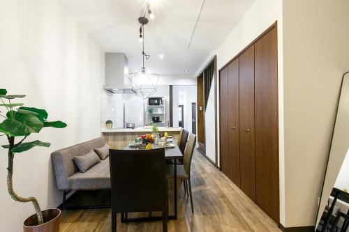 a kitchen and dining room with a table and chairs at Tsutsuicho STAY in Nagoya
