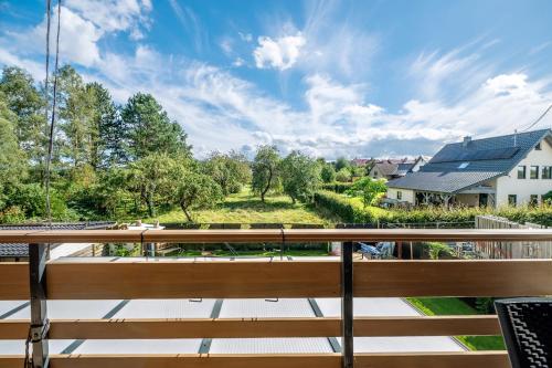 a view from the balcony of a house with a bench at Ut Huuske in Dorsel