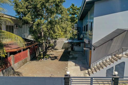 an empty alley between two buildings with trees at JCzar Suites in Gingoog