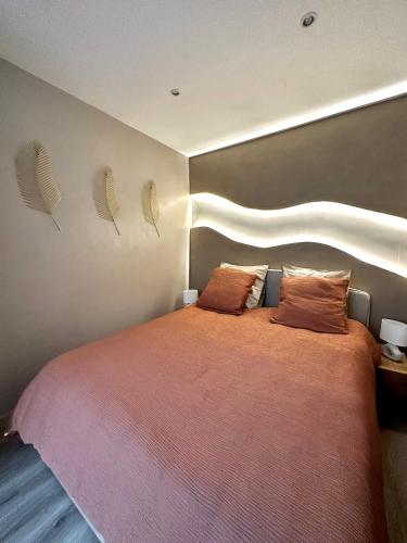 une chambre avec un grand lit avec deux oreillers dans l'établissement Maison cosy jungle urbaine, à Dammartin-en-Goële